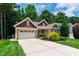 Charming home with a well-manicured lawn, mature landscaping, and an attached two-car garage at 553 Lake Gaston Dr, Fuquay Varina, NC 27526