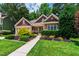 Beautiful home with a well-manicured lawn, mature landscaping, and a welcoming walkway at 553 Lake Gaston Dr, Fuquay Varina, NC 27526