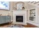Cozy living space featuring a fireplace with mantel, and a built-in bookshelf providing functional storage space at 553 Lake Gaston Dr, Fuquay Varina, NC 27526