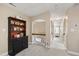 Hallway with arched doorway and black cabinet with open shelving on the left at 553 Lake Gaston Dr, Fuquay Varina, NC 27526