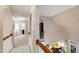 Upstairs hallway showcases hardwood stair rail and view of eat-in kitchen area at 553 Lake Gaston Dr, Fuquay Varina, NC 27526