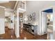 Hallway with wooden floors, leading to an open concept kitchen, multiple rooms and access to stairs at 553 Lake Gaston Dr, Fuquay Varina, NC 27526