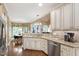 Open kitchen with granite counters, stainless steel appliances, and a view of the breakfast nook and Gathering room at 553 Lake Gaston Dr, Fuquay Varina, NC 27526