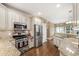 Well-lit kitchen featuring stainless steel appliances, light-colored cabinetry, and granite countertops at 553 Lake Gaston Dr, Fuquay Varina, NC 27526