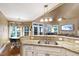 Open kitchen with granite counters and stainless steel sink overlooking the breakfast nook at 553 Lake Gaston Dr, Fuquay Varina, NC 27526