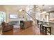 Spacious living room with wood floors, fireplace, and staircase leading to a second level at 553 Lake Gaston Dr, Fuquay Varina, NC 27526