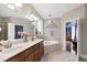 Bright bathroom features a double vanity, soaking tub with decorative window, and natural light at 553 Lake Gaston Dr, Fuquay Varina, NC 27526