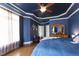 Spacious main bedroom featuring a striking blue color scheme and tray ceiling with wood fan at 553 Lake Gaston Dr, Fuquay Varina, NC 27526