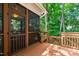 Outdoor screened porch and view to the wooded backyard, perfect for enjoying the outdoors in comfort and style at 553 Lake Gaston Dr, Fuquay Varina, NC 27526