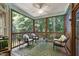 Inviting screened porch with wicker furniture and view of wooded backyard, perfect for relaxation and entertaining at 553 Lake Gaston Dr, Fuquay Varina, NC 27526