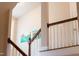 Staircase with a wood railing and views of artwork on the wall at 553 Lake Gaston Dr, Fuquay Varina, NC 27526