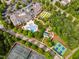 Aerial view of community clubhouse with pool, tennis courts, landscaping, and parking for residents to enjoy at 575 Tomkins Loop, Cary, NC 27519