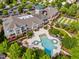 Aerial shot of the clubhouse, featuring a pool, bowling lawns, and lush landscaping at 575 Tomkins Loop, Cary, NC 27519