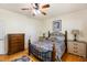 Comfortable bedroom showcasing hardwood floors, a wooden bed frame, and matching dressers at 575 Tomkins Loop, Cary, NC 27519
