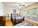 Charming bedroom with a wood-framed bed, hardwood floors, and two bedside tables with lamps at 575 Tomkins Loop, Cary, NC 27519