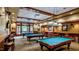 Upscale community billiard room with pool tables, bar seating, and ambient lighting for relaxation and entertainment at 575 Tomkins Loop, Cary, NC 27519