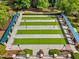Overhead view of bocce ball court and seating area with decorative landscaping and mature shade trees in this community at 575 Tomkins Loop, Cary, NC 27519