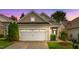 Charming home with a two-car garage, beautiful siding, manicured lawn, and inviting curb appeal at sunset at 575 Tomkins Loop, Cary, NC 27519