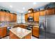Well-equipped kitchen with stainless steel appliances, granite countertops, and a functional island at 575 Tomkins Loop, Cary, NC 27519