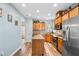 Spacious kitchen with stainless steel appliances, granite counters, center island, and wood cabinets at 575 Tomkins Loop, Cary, NC 27519