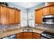 Close-up of kitchen featuring stainless steel appliances, granite countertops, and ample cabinet space at 575 Tomkins Loop, Cary, NC 27519