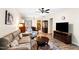 Open living room boasts hardwood floors, ceiling fan, and a view into the kitchen and dining area at 575 Tomkins Loop, Cary, NC 27519