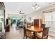 The living room has a ceiling fan and hardwood floors and opens to the outside patio at 575 Tomkins Loop, Cary, NC 27519