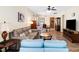 Spacious living room featuring hardwood floors, cozy seating, and a view into the kitchen at 575 Tomkins Loop, Cary, NC 27519