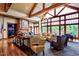 Expansive community living room with a stone fireplace, large windows, and comfortable seating, perfect for gatherings at 575 Tomkins Loop, Cary, NC 27519