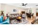 Comfortable living room showcasing hardwood floors, a ceiling fan, and a cozy seating area at 575 Tomkins Loop, Cary, NC 27519