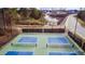 Overhead view of the pickleball courts in a community with a water feature, park, and road nearby at 575 Tomkins Loop, Cary, NC 27519