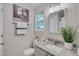 Clean bathroom with granite counters, neutral walls, and a vanity mirror at 5905 Westcreek Pl, Raleigh, NC 27606