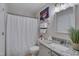Clean bathroom featuring granite counters, neutral walls, and a shower with curtain at 5905 Westcreek Pl, Raleigh, NC 27606