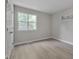 Bright bedroom with hardwood floors, neutral walls, and a large window at 5905 Westcreek Pl, Raleigh, NC 27606