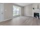 Bright living room featuring hardwood floors, a fireplace, and a large window at 5905 Westcreek Pl, Raleigh, NC 27606