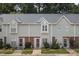 Charming townhome exterior with light gray siding, brick accents, and well-maintained landscaping at 6 Parsons Chase Ln, Durham, NC 27713