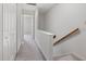 Bright hallway with carpet, railing, and a view into another room at 6 Parsons Chase Ln, Durham, NC 27713
