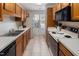 Functional kitchen with wood cabinets, white countertops, and a window for natural light at 6 Parsons Chase Ln, Durham, NC 27713