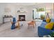 Bright living room with a cozy fireplace, neutral carpet, and a sliding door to the outside at 6 Parsons Chase Ln, Durham, NC 27713