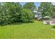 Backyard featuring an umbrella and lush green grass at 611 Quartz Dr, Durham, NC 27703