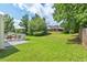 Large backyard with a patio, lush green grass, and trees at 611 Quartz Dr, Durham, NC 27703