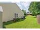 Well-maintained backyard with lush green grass, a small garden, and a grill near the house at 611 Quartz Dr, Durham, NC 27703