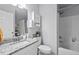 Well-lit bathroom featuring a shower-tub combination and granite countertops at 611 Quartz Dr, Durham, NC 27703