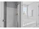 Bathroom featuring a bathtub and a shower stall with a glass door at 611 Quartz Dr, Durham, NC 27703