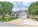 Inviting single-story home with attached garage, and a well-manicured front yard at 611 Quartz Dr, Durham, NC 27703