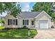 Charming single-story home featuring a well-maintained lawn, attached garage, and inviting curb appeal at 611 Quartz Dr, Durham, NC 27703