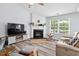 Comfortable living room featuring a fireplace, large window, and neutral décor at 611 Quartz Dr, Durham, NC 27703