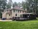 Backyard featuring a large deck, screened in porch, and fountain at 6225 Acorn Ridge Trl, Hillsborough, NC 27278