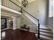 Elegant foyer with staircase and view to kitchen, creating a grand entrance at 6225 Acorn Ridge Trl, Hillsborough, NC 27278