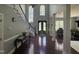 Grand foyer with a staircase, chandelier, and decorative front door, creating a welcoming entrance at 6225 Acorn Ridge Trl, Hillsborough, NC 27278